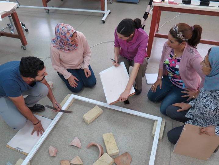 Photo of Katharyn teaching measured drawing with students in Iraq: Dr. Katharyn Hanson teaching participants in a training at the Iraqi Institute for the Conservation of Antiquities and Heritage, in Erbil, Iraq. Photograph by the Iraqi Institute for the Conservation of Antiquities and Heritage